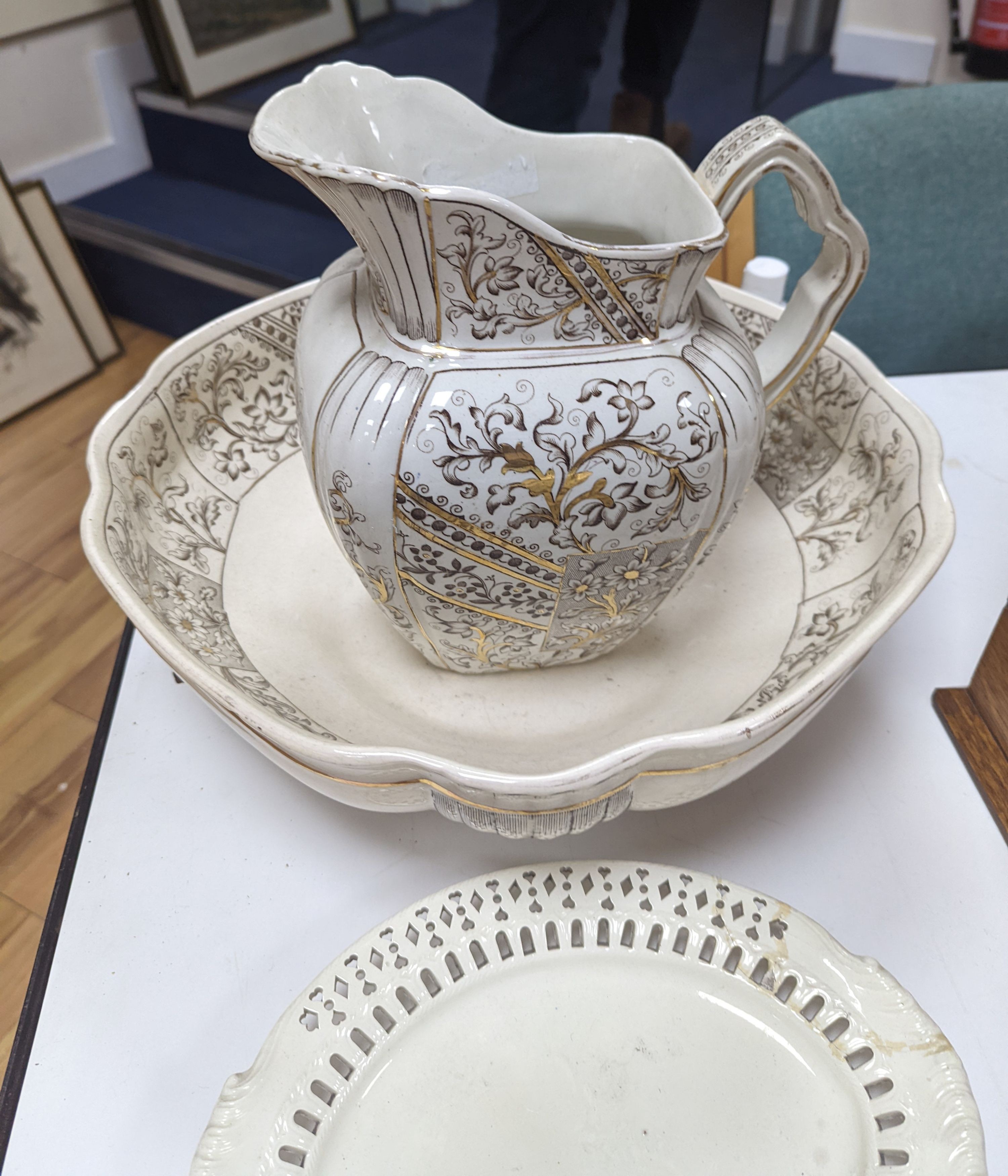 An English 18th century creamware chestnut dish and stand and a serpentine dish, A gilt decorated jug and basin and a teapot, jug and basin set, 30cms high